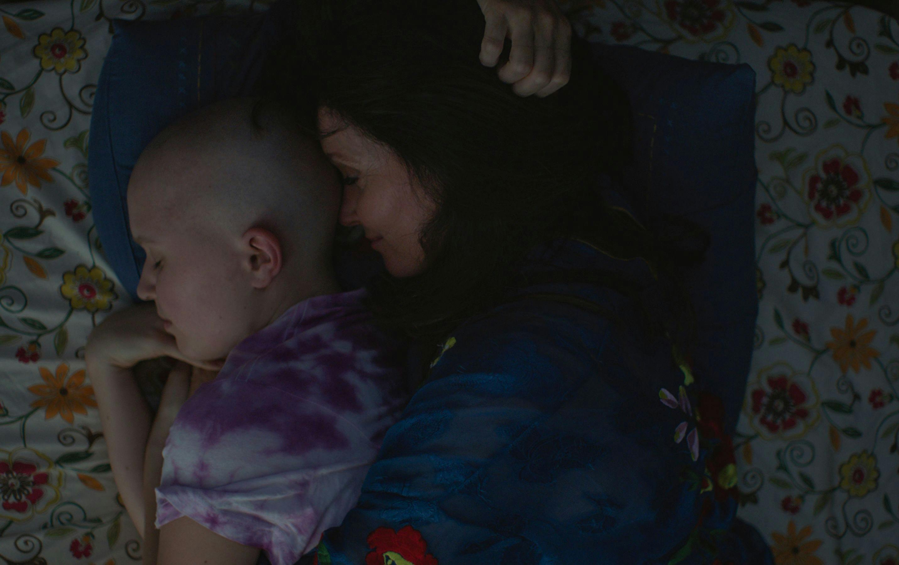 Essie and Eliza cuddling in bed
